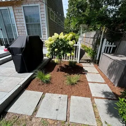 Garden bed with hydrangea and bluestone steppers